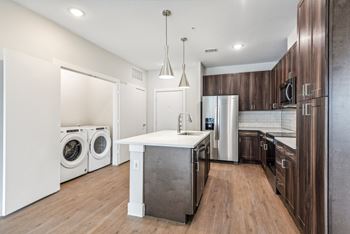 a laundry room with a washer and dryer and a sink in a kitchen at The Virginia, Texas, 78155